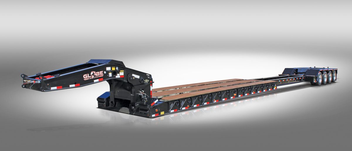 Black extendable tri-axle lowboy with hydraulic flip axle stretched out